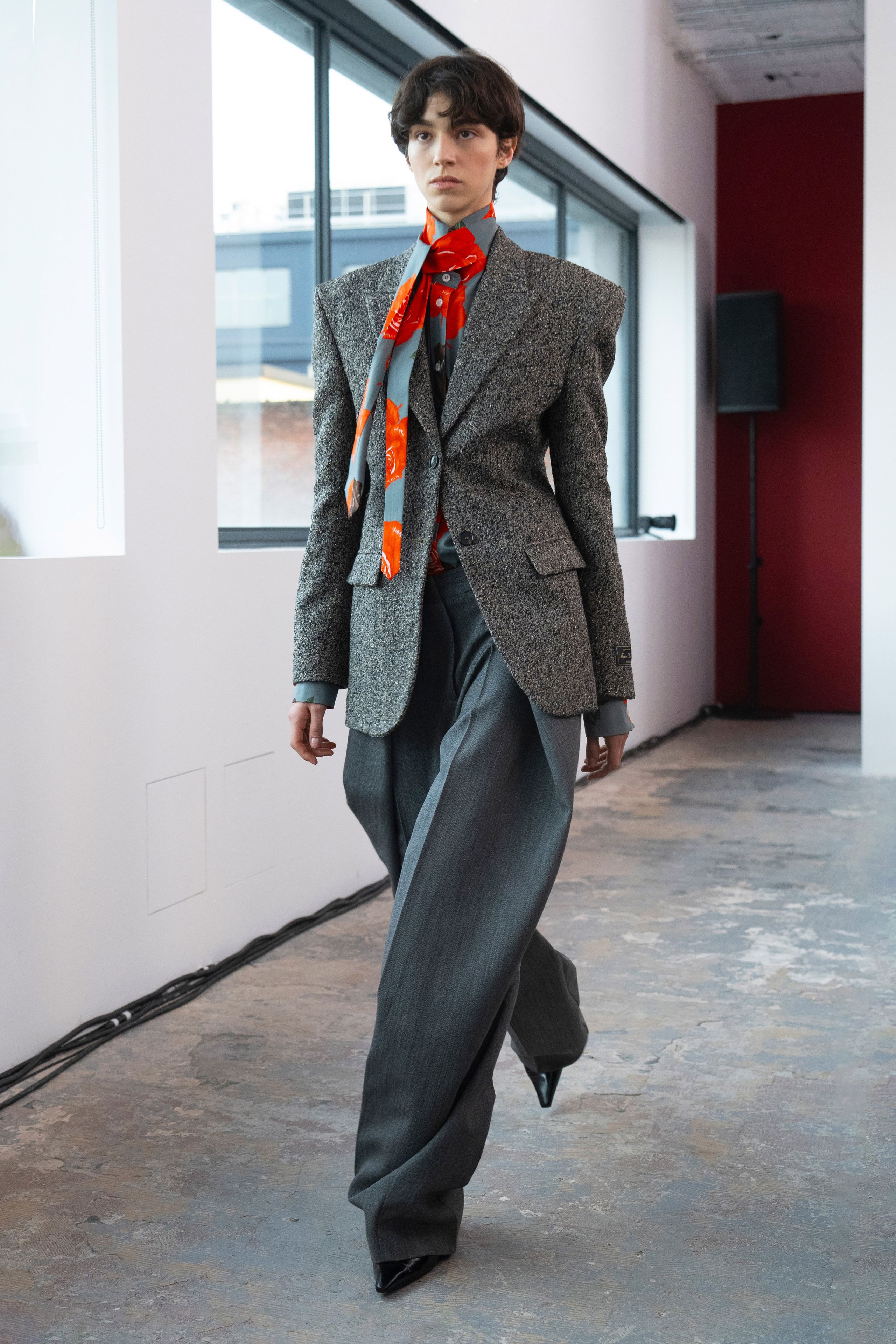 Image may contain Blazer Clothing Coat Jacket Formal Wear Suit Pants and Scarf