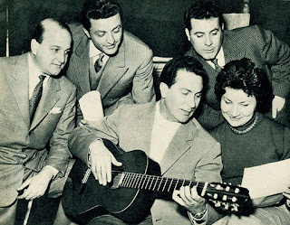 Savina, who played a wide range of instruments, is shown accompanying a vocal group on guitar Savina, who played a wide range of instruments, is shown accompanying a vocal group on guitar
