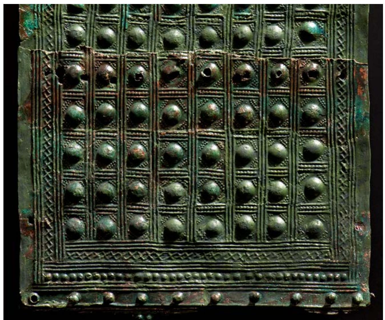 Figure 3. Bronze belt plate from Ravensburg-Berg, Ha D2, with embossed knobs and crosses, produced with punches and negatively engraved ornamentation (photo H. Zwietasch). 
