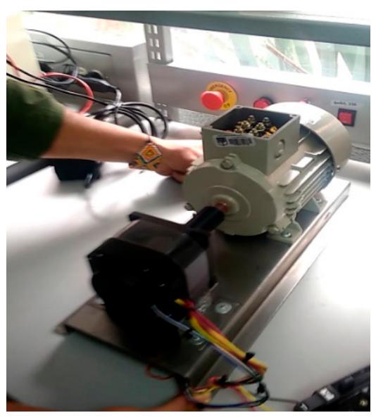 Figure 16. Test bench for the BLY342S-48V-3200 motor.  Two different test benchmarks are used for the assessment of each of the motor torque controllers. The first platform is a stationary bench, which allows easy adjustment of the BLDC motor load. This bench is based on an induction motor directly coupled to the BLDC motor under test as shown in Figure 16. The load (Siemens 1LA7 070-4YC60 motor) is controlled using a Sinamics G120 inverter operating in vector mode to adjust the torque delivered to the BLDC motor. 