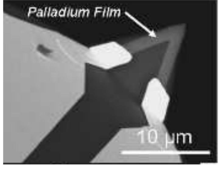 Figure 23. SEM image of a Thermoresistive probe.  The thermoresistive tips used for scanning thermal microscopy are mostly conical in shape with a spherical tip apex for optimal tip thermal conductance and a spring constant of around 0.3 N/m [26]. The tip radius of curvature of modern thermoresistive probes are around 50 nm and they have a very short time response, around few tens of microsecond with the temperature coefficient of the electrical resistance at around 0.0012 /K [27]. The probe tip is around 10 um. This length allows creating separation necessary between the cantilever and the sample, which thereby, notably in case of hot sample in thermometric measurements, reduces the cantilever  heating. A SEM image of the tip of a thermoresistive micro-fabricated probe is given in Figure  heating. A SEM image of the tip of a thermoresistive micro-fabricated probe is given in Figure 