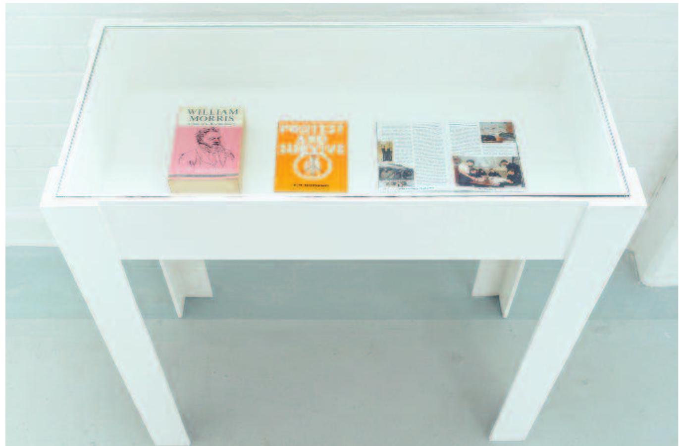 Figure 13: David Mabb, A Provisional Memorial to Nuclear Disarmament, display cabinet containing: E. P. Thompson, William Morris: Romantic to Revolutionary, 2nd rev. edn (London: Merlin, 1977); E. P Thompson, Protest and Survive, 2nd rev. edn (London: Campaign for Nuclear Disarmament, 1980); HMS Courageous:A veteran of the Cold War (Courageous Society, 201 3), open at pp. 52-53 showing ‘Officers in the Wardroom’ with William Morris Tudor Rose fabric on the seating. KARST, Plymouth 2016. Photo: Dom Moore. 
