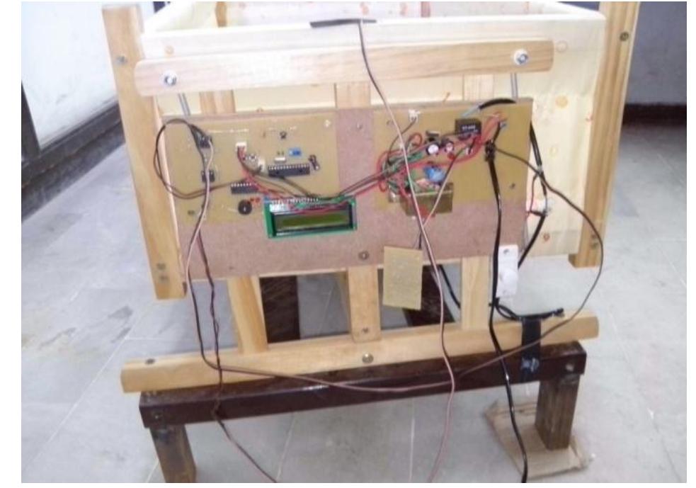 Fig 5 shows the electronic board connected to cradle which consist of transformer, microcontroller and peripheral devices including LCD, op-amp, wet sensor, relay and switches. A transformer steps down 220V AC to 15V AC. Further LM7805 steps down 15V DC to 5V DC which inputs to microcontroller and other peripherals.  Fig 5: Electronic board connected with cradle 