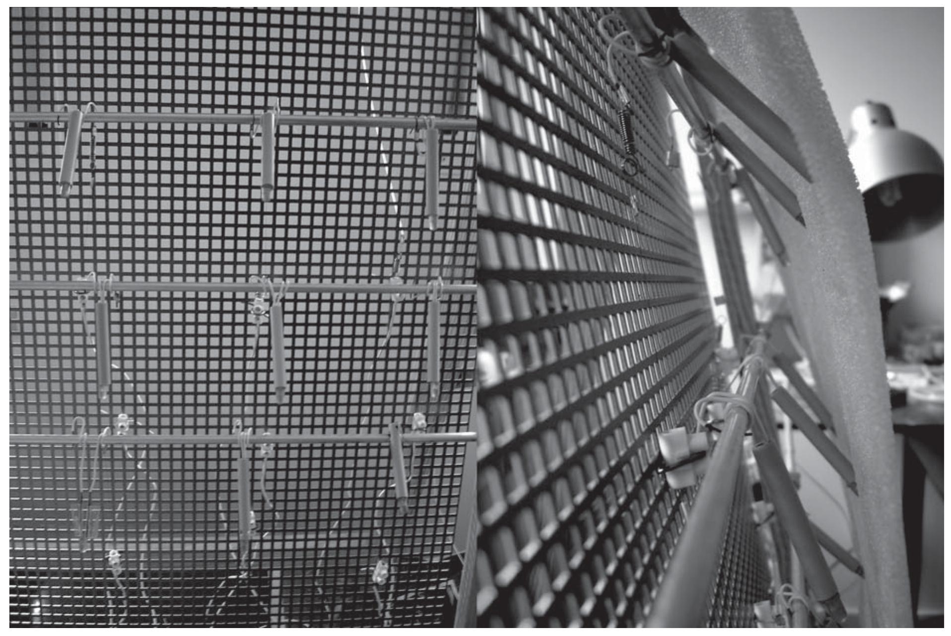 FIGURE 1 “The Life of a Wall”: views of SMA’s actuators.  in order to consider the possibility of realizing an artl- ficial model of a “living machine,” we should consider how life systems could be formalized within the con- ventional formal theories. But first we should start by asking what life is? It seems that it is difficult to agree on a universal definition of life. Life is too complex, the answers are not simple, and certainly not the subject of clear consensus. It is nevertheless established that certain features are naturally mentioned: self-organi- zation, emergence, autonomy, growth, development, reproduction, adaptation, responsiveness, evolution, and metabolism (Boden 2000). That all of these fea- tures are essential to life is dubious. There is genera agreement, however, that the core concept of life is “self-organization:” the emergence (and maintenance) of order, out of an origin that is ordered to a lesser degree by means of fundamental and autonomous structura development. “Self-organization” is the core concept because it necessarily involves some of the other items on the list, and because the remainder are all specia cases of it. Thus, emergence, autonomy, and develop- ment are related concepts, included in the definition of “self-organization,” whereas, growth, reproduction, adaptation, responsiveness, evolution, and metabolism   Inspired by the theory of Autopoiesis, this paper seeks to describe a model for a “self-producing” machine in architecture as opposed to a “produced” or allopoi- etic machine. Allopoietic machines have as a product of their functioning something different from them- 